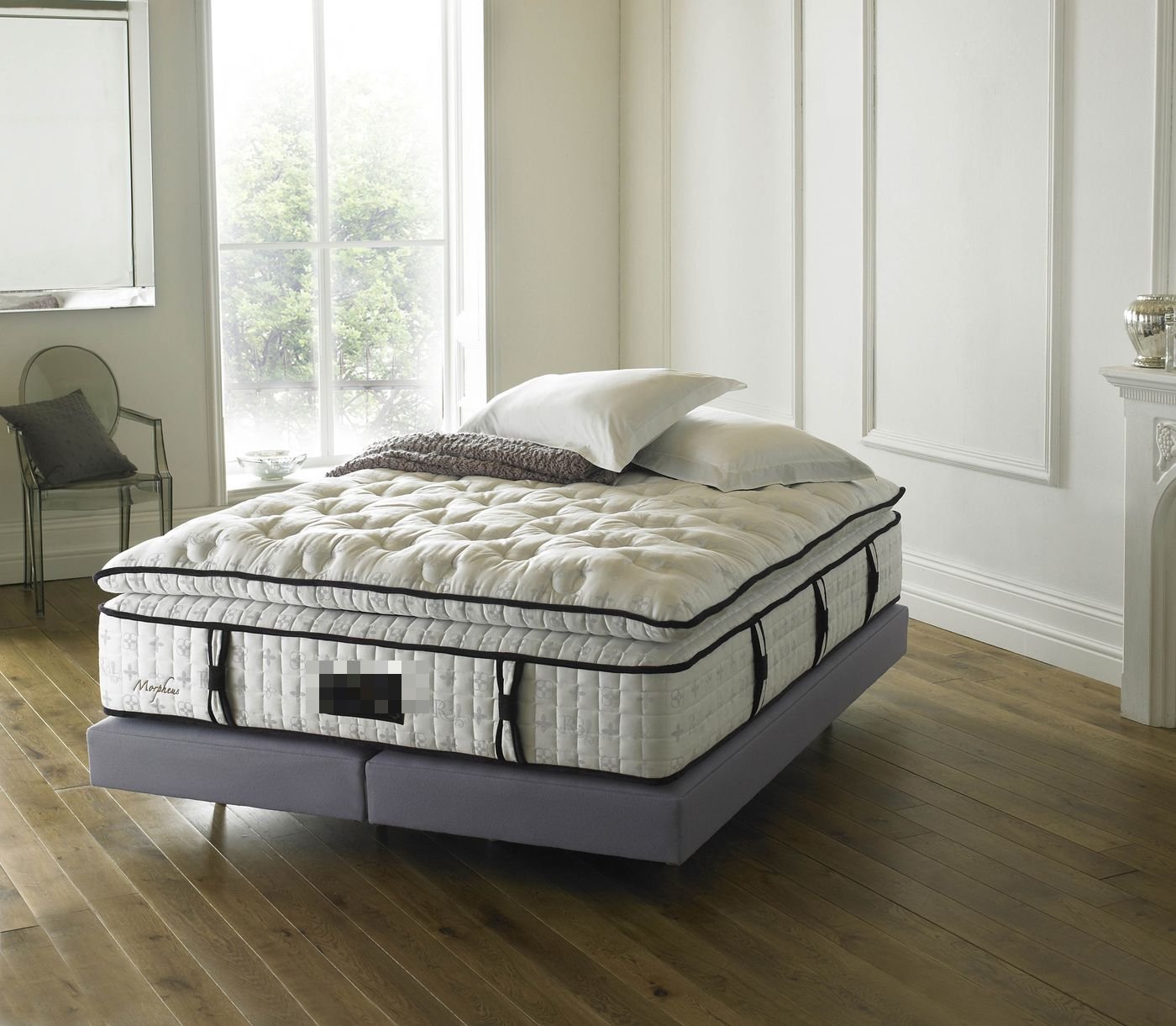 Royal Bohemia Morpheus mattress on a grey bed frame in a bright period bedroom with a fireplace