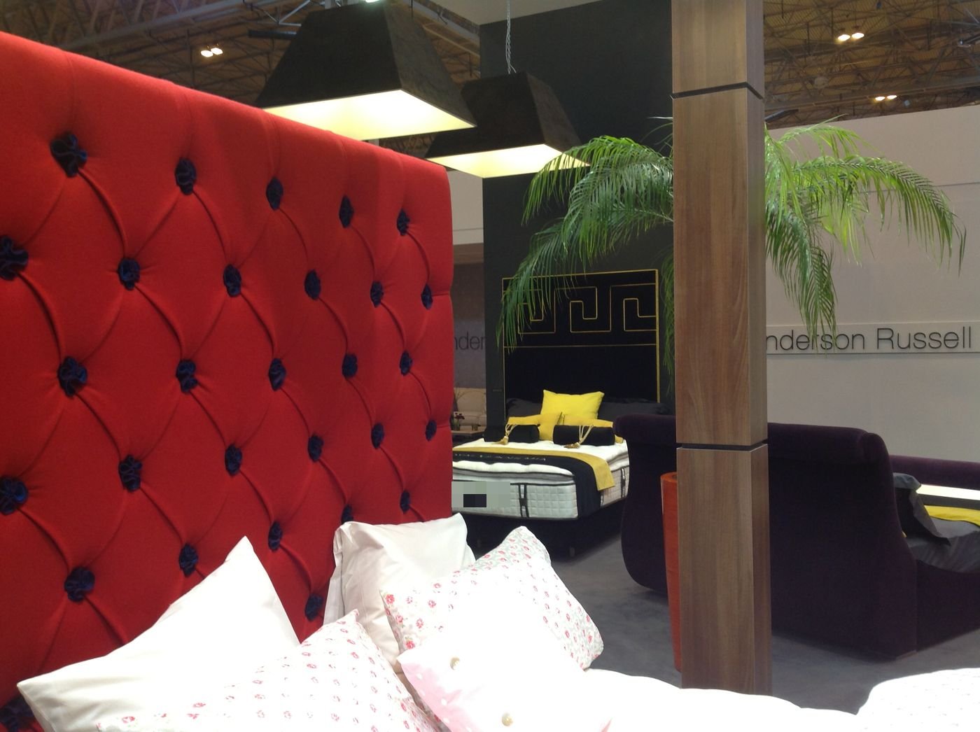 Royal Bohemia trade show display featuring purple, yellow and cream headboard panels