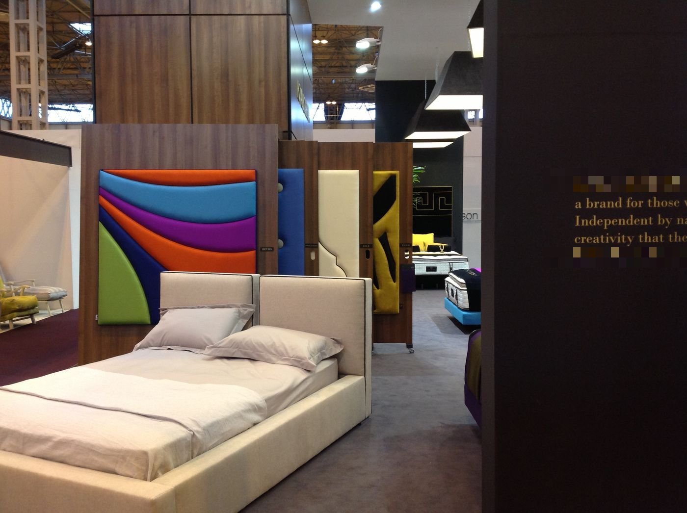 Royal Bohemia trade show display of colourful headboard panels in orange, purple, blue and green