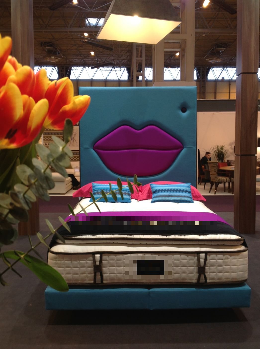 Royal Bohemia showroom display of a teal headboard with a purple lips-shaped panel design