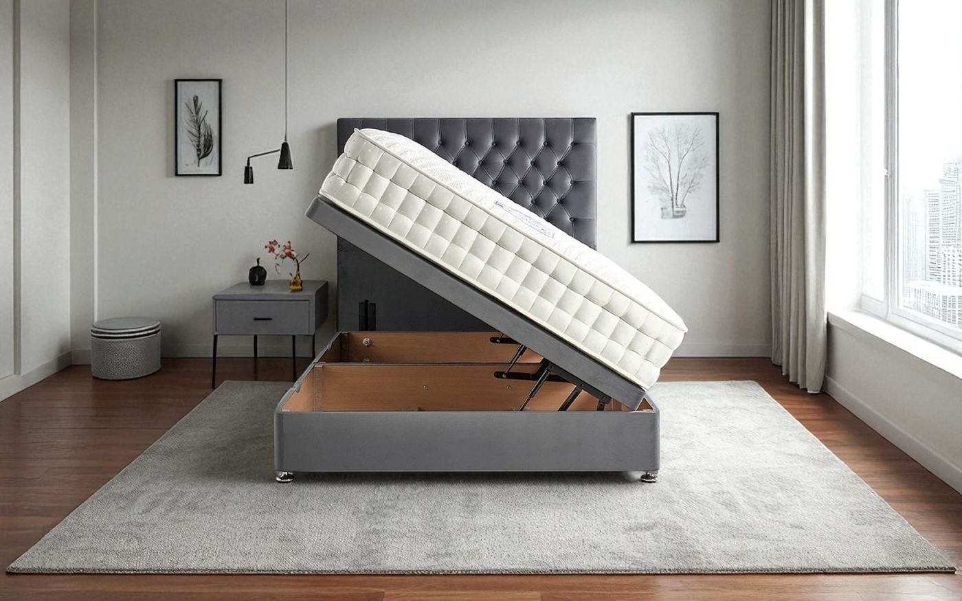 Dark grey ottoman storage bed with the mattress base lifted to show the gas-strut storage compartment